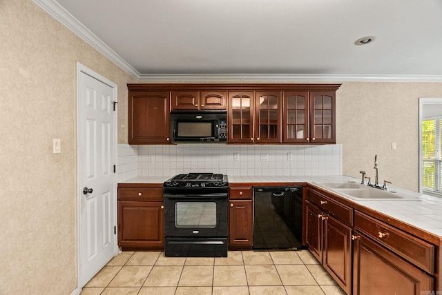 kitchen with glass insert cabinets, black appliances, decorative backsplash, tile countertops, and a sink