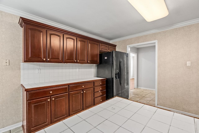 kitchen featuring light tile patterned floors, black fridge with ice dispenser, ornamental molding, tile counters, and decorative backsplash