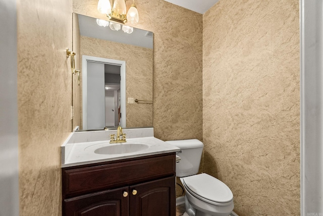 bathroom with toilet and vanity