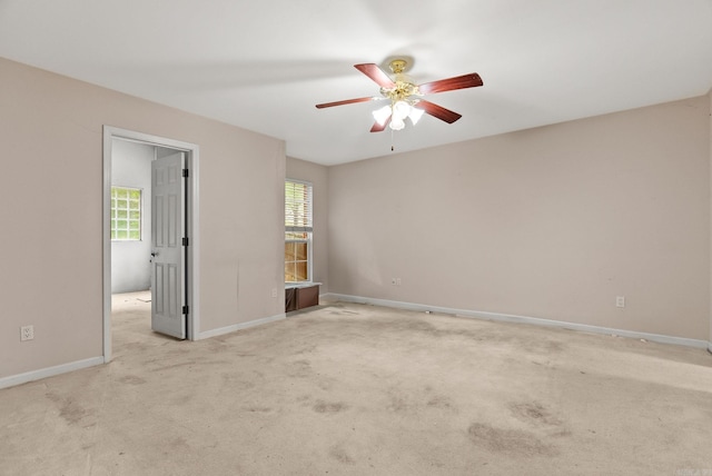 unfurnished room with carpet flooring, baseboards, and ceiling fan