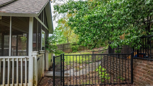 view of gate with a fenced backyard