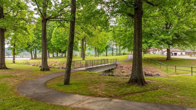 view of property's community featuring a yard and fence
