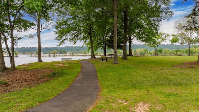 surrounding community featuring a yard and a water view