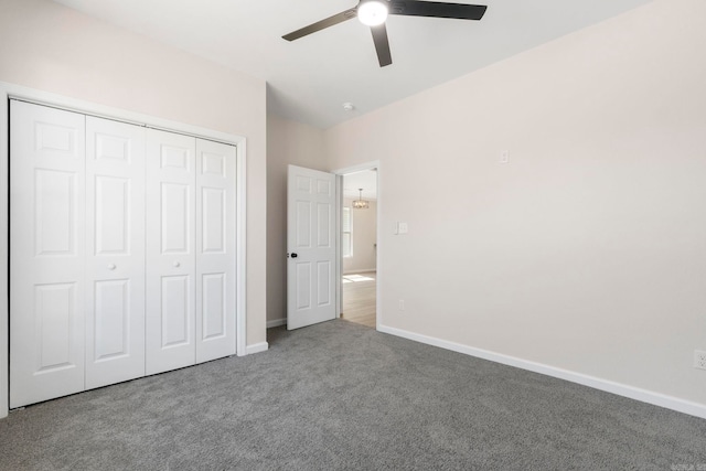unfurnished bedroom featuring carpet floors, baseboards, a closet, and ceiling fan