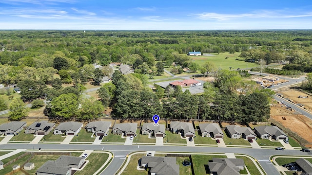 bird's eye view featuring a view of trees and a residential view