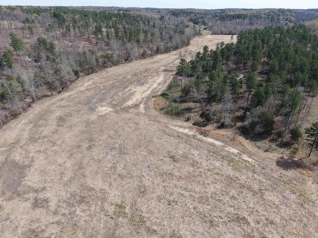 drone / aerial view with a wooded view