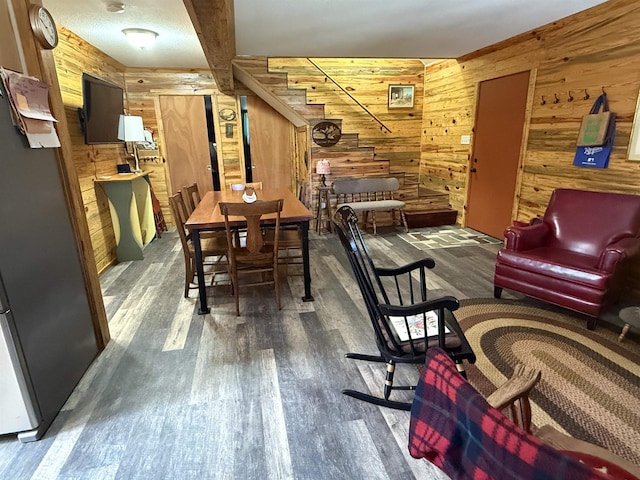 dining room featuring wood finished floors and wood walls