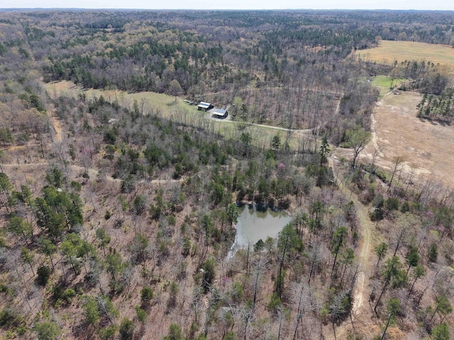 drone / aerial view with a water view and a forest view
