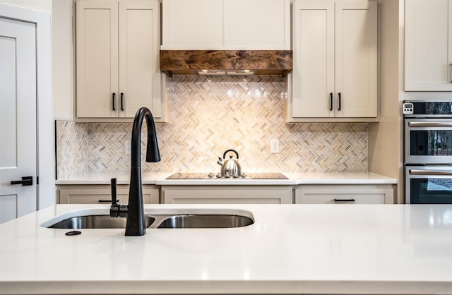 kitchen featuring light countertops, double oven, and decorative backsplash