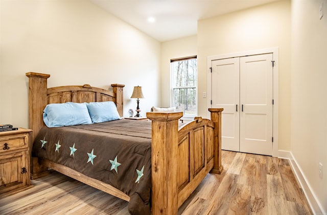 bedroom with baseboards and light wood finished floors