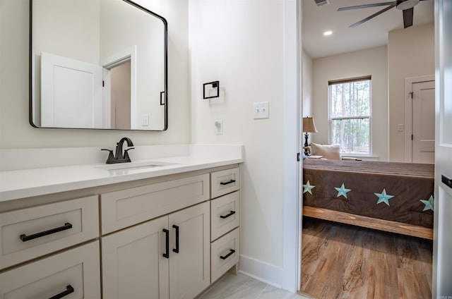bathroom featuring visible vents, baseboards, a ceiling fan, vanity, and wood finished floors