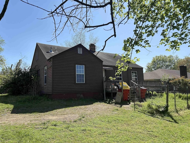 604 E Church St, Morrilton, AR 72110 - exterior space featuring a yard, a chimney, a wooden deck, and roof with shingles