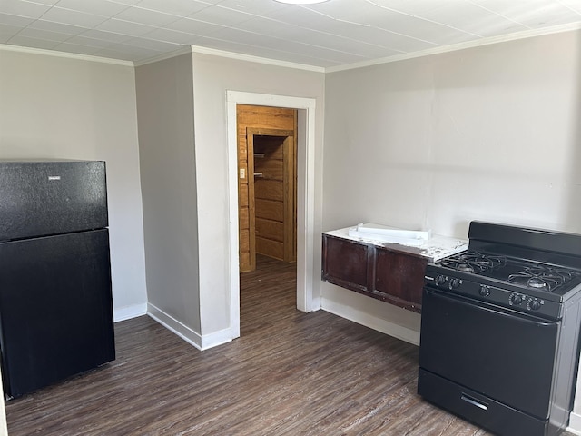 604 E Church St, Morrilton, AR 72110 - kitchen with baseboards, dark wood-style flooring, ornamental molding, light countertops, and black appliances
