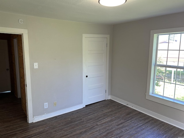 604 E Church St, Morrilton, AR 72110 - empty room with baseboards and dark wood finished floors