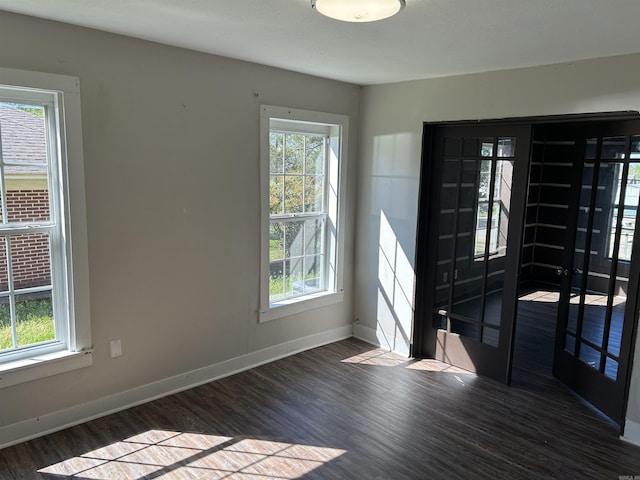 604 E Church St, Morrilton, AR 72110 - spare room featuring a healthy amount of sunlight, wood finished floors, and baseboards