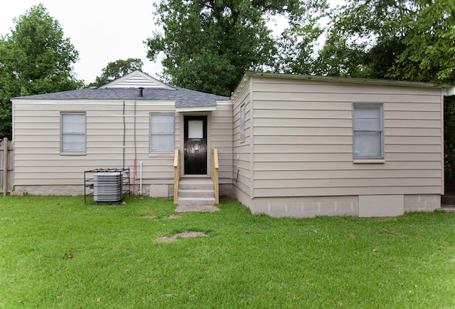 301 Boggs St, North Little Rock, AR 72117 - rear view of house with central AC, a shingled roof, entry steps, a yard, and crawl space