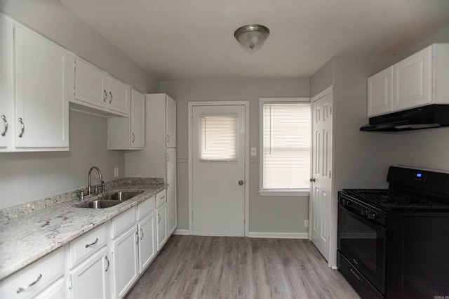 301 Boggs St, North Little Rock, AR 72117 - kitchen featuring under cabinet range hood, gas stove, a sink, and white cabinets