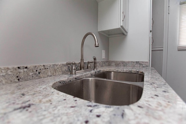 301 Boggs St, North Little Rock, AR 72117 - interior details with a sink, white cabinets, and light stone countertops