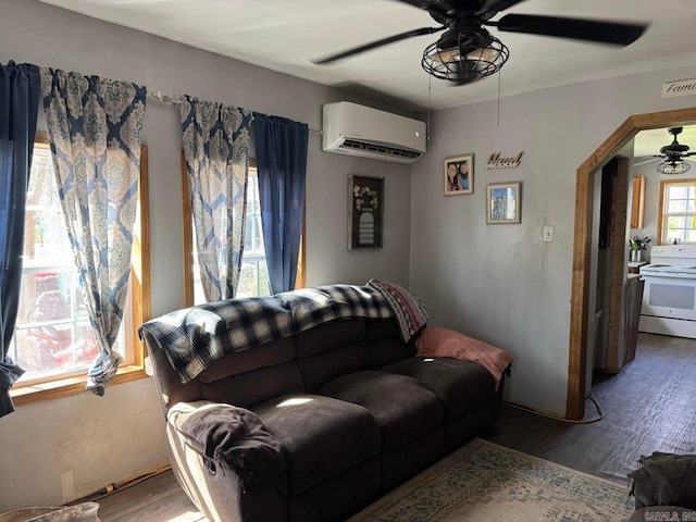 95 Terrafirma Ln, Ash Flat, AR 72513 - living area featuring arched walkways, a ceiling fan, visible vents, wood finished floors, and a wall mounted air conditioner