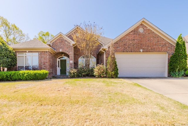 3015 Woodsgate, Little Rock, AR 72211 - view of front of property featuring concrete driveway, a front yard, brick siding, and an attached garage