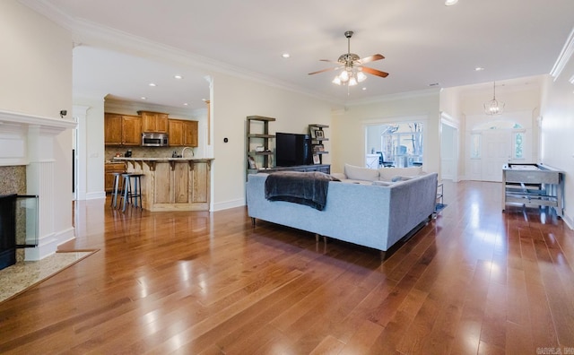 3015 Woodsgate, Little Rock, AR 72211 - living room with recessed lighting, ceiling fan, crown molding, and wood finished floors