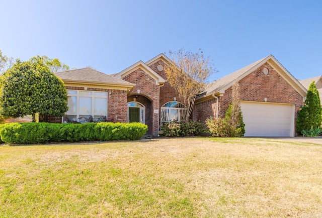 3015 Woodsgate, Little Rock, AR 72211 - view of front facade with an attached garage, driveway, a front lawn, and brick siding
