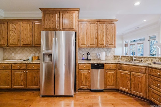 3015 Woodsgate, Little Rock, AR 72211 - kitchen featuring stainless steel fridge with ice dispenser, ornamental molding, brown cabinets, and a sink