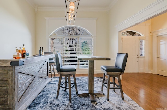 3015 Woodsgate, Little Rock, AR 72211 - dining area with crown molding, a towering ceiling, and wood finished floors