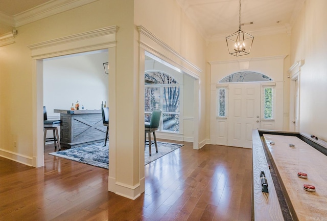 3015 Woodsgate, Little Rock, AR 72211 - foyer featuring an inviting chandelier, dark wood-type flooring, and ornamental molding