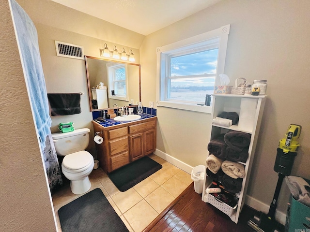 2832 Lacrosse Rd, Melbourne, AR 72556 - bathroom featuring vanity, visible vents, toilet, tile patterned floors, and baseboards