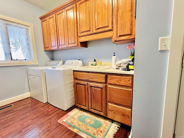 2832 Lacrosse Rd, Melbourne, AR 72556 - clothes washing area with visible vents, wood finished floors, baseboards, cabinet space, and washer and clothes dryer