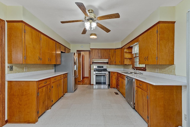 2812 N Church, Jonesboro, AR 72401 - kitchen featuring a sink, ceiling fan, brown cabinets, stainless steel appliances, and light floors