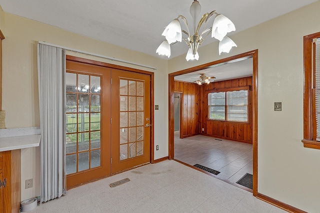 2812 N Church, Jonesboro, AR 72401 - doorway to outside featuring baseboards, a chandelier, tile patterned floors, wood walls, and visible vents