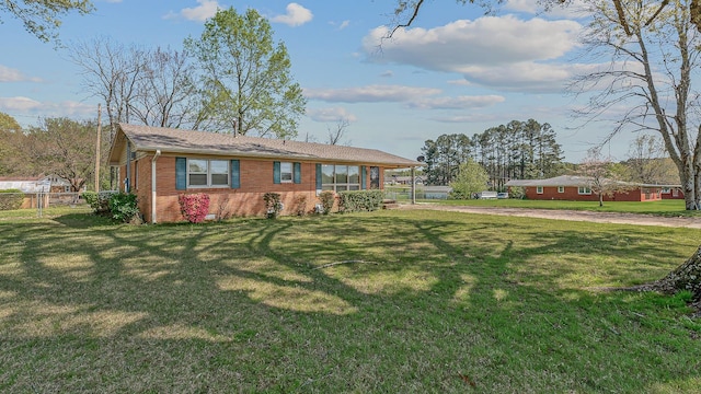 2812 N Church, Jonesboro, AR 72401 - view of front of property featuring a front yard, brick siding, and fence