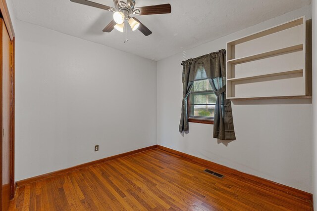 2812 N Church, Jonesboro, AR 72401 - spare room with visible vents, ceiling fan, hardwood / wood-style floors, and baseboards