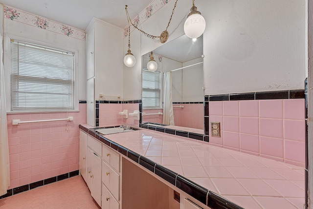 2812 N Church, Jonesboro, AR 72401 - full bathroom with a shower with shower curtain, vanity, tile walls, and wainscoting