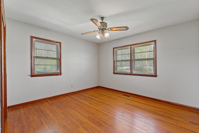 2812 N Church, Jonesboro, AR 72401 - empty room featuring visible vents, baseboards, a ceiling fan, and hardwood / wood-style floors