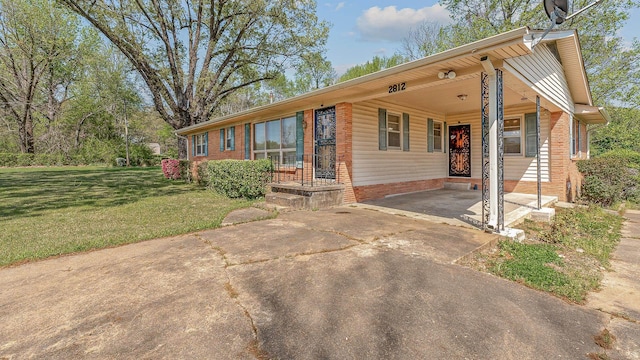 2812 N Church, Jonesboro, AR 72401 - single story home featuring concrete driveway, an attached carport, a front lawn, and brick siding