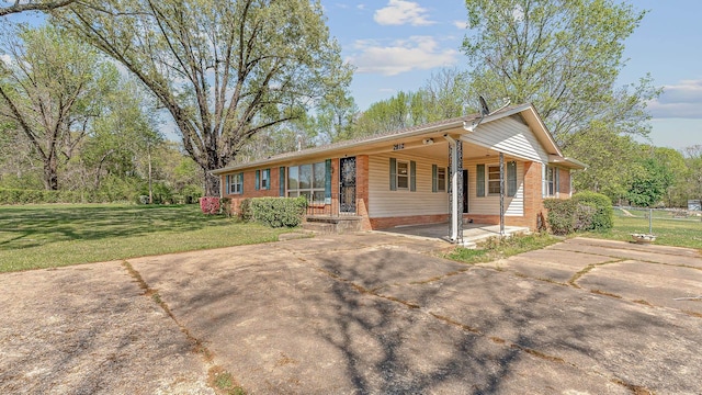 2812 N Church, Jonesboro, AR 72401 - ranch-style home with a carport, concrete driveway, a front yard, and brick siding