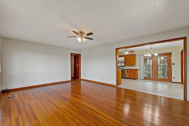 2812 N Church, Jonesboro, AR 72401 - unfurnished living room with light wood-style floors, ceiling fan with notable chandelier, and baseboards