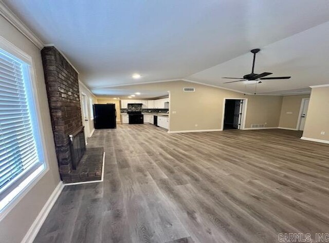 131 Maribeth St, Forrest City, AR 72335 - unfurnished living room featuring baseboards, a ceiling fan, and a healthy amount of sunlight