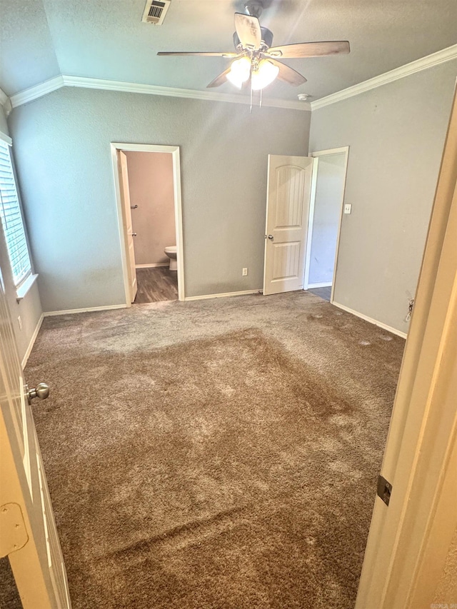 unfurnished bedroom with ornamental molding, baseboards, and carpet flooring