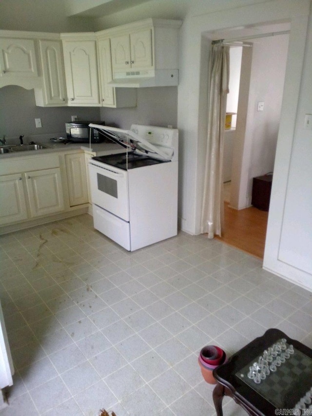 3419 Dr Martin Luther King Dr, Little Rock, AR 72206 - kitchen with white electric range, light tile patterned flooring, a sink, and under cabinet range hood