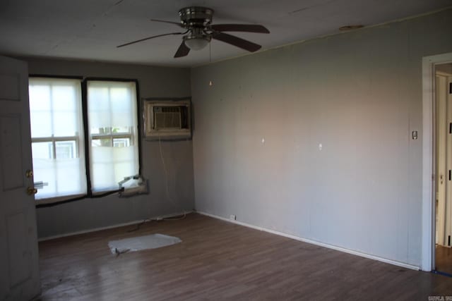 spare room with ceiling fan, wood finished floors, and a wall unit AC
