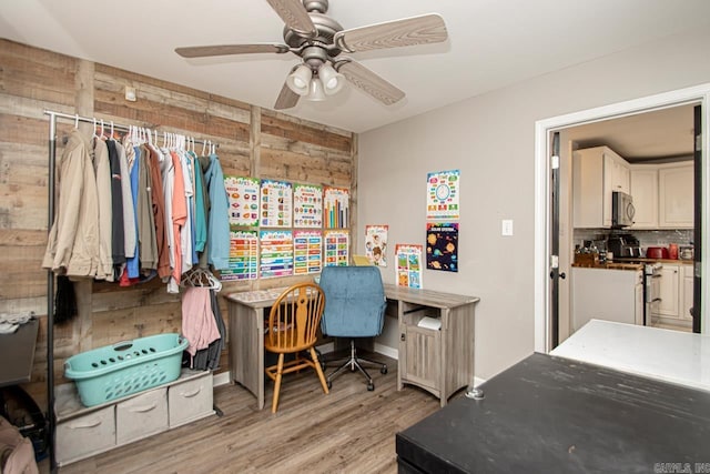 3712 Hazelwood Dr, Benton, AR 72015 - office space with wooden walls, a ceiling fan, and light wood finished floors