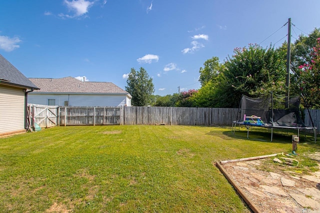 3712 Hazelwood Dr, Benton, AR 72015 - view of yard with a fenced backyard and a trampoline
