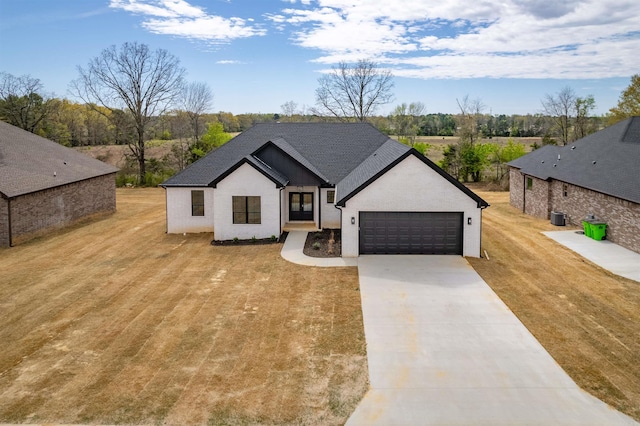 240 Michelle Dr, Beebe, AR 72012 - view of front facade featuring central AC, a front lawn, an attached garage, a shingled roof, and driveway