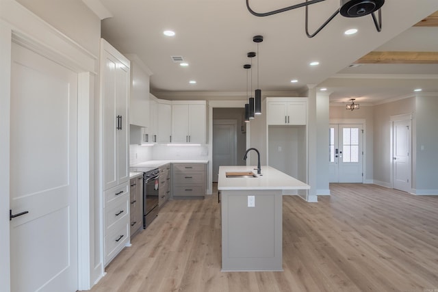 240 Michelle Dr, Beebe, AR 72012 - kitchen featuring an island with sink, ornamental molding, visible vents, a sink, and range with electric stovetop