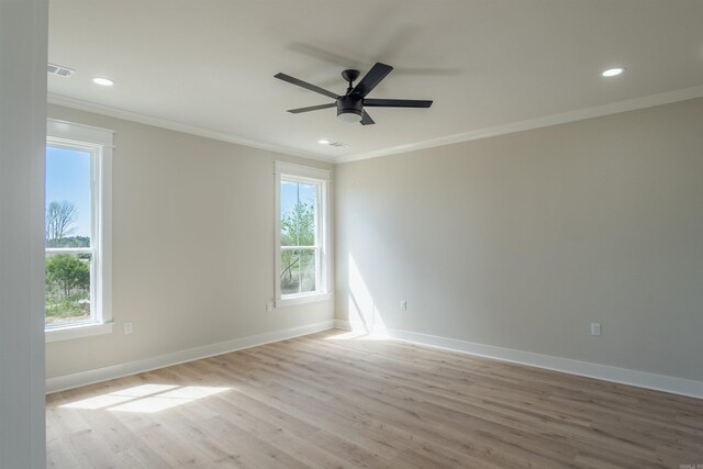 240 Michelle Dr, Beebe, AR 72012 - unfurnished room with crown molding, a healthy amount of sunlight, visible vents, and light wood-style floors