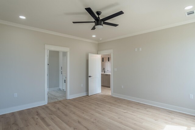 240 Michelle Dr, Beebe, AR 72012 - unfurnished bedroom featuring ensuite bathroom, crown molding, light wood-style floors, visible vents, and a sink